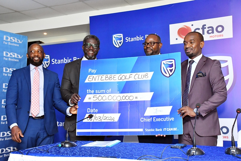 Arthur Kiwanuka,Stanbic's Head of Affluent Banking and Sam Mwogeza,Stanbic's Executive Head of Personal and Private Banking handover a dummy cheque to the Entebbe Club Chairman and Captain recently