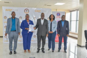 Eng. Irene Pauline Bateebe, Permanent Secretary in the Ministry of Energy (centre), UEDCL’s Managing Director, Paul Mwesigwa (right), and other Ministry officials at the signing of the agreement