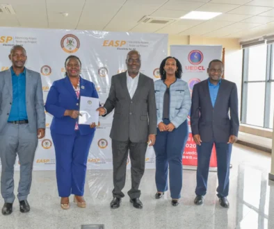 Eng. Irene Pauline Bateebe, Permanent Secretary in the Ministry of Energy (centre), UEDCL’s Managing Director, Paul Mwesigwa (right), and other Ministry officials at the signing of the agreement