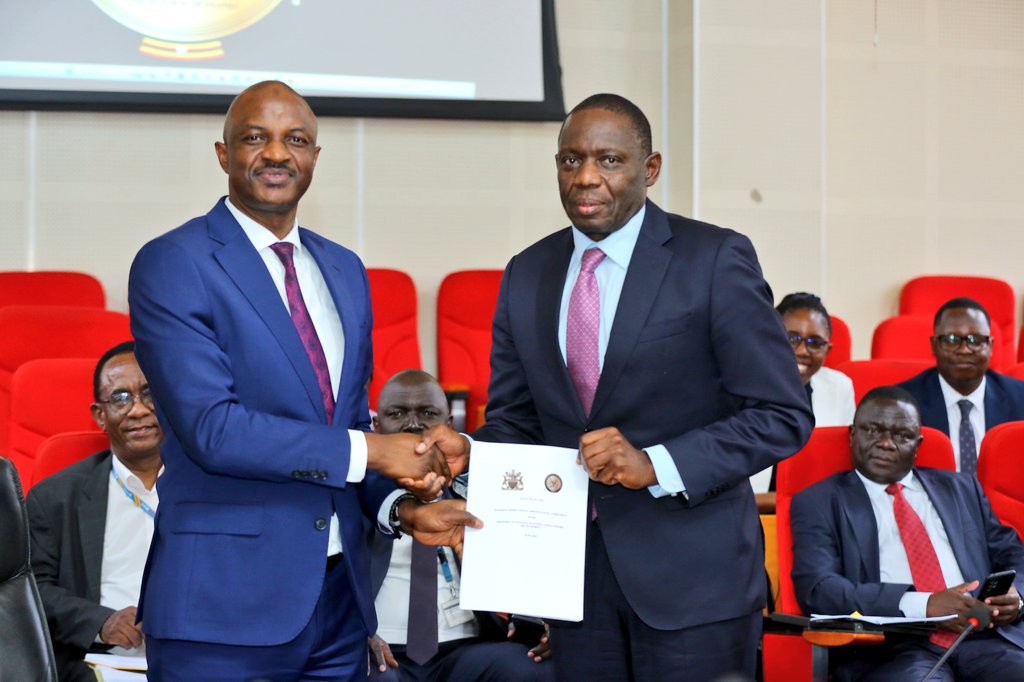 PSST Ramathan Ggoobi and the Governor Bank of Uganda after endorsing the agreement