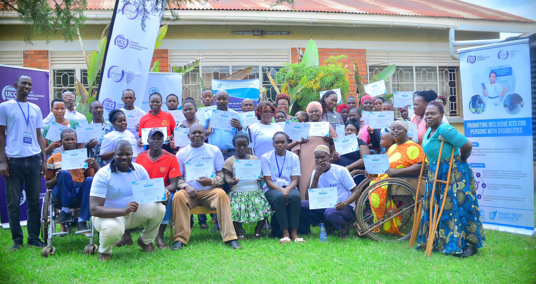 UCC and UCUSAF officials with some of the disabled beneficiaries of the digital skills programme