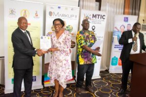 Minister of state for trade. Gen. Wilson Mbadi award a certificate to one of the packaging trainees Minister of state for trade. Gen. Wilson Mbadi award a certificate to one of the packaging trainees