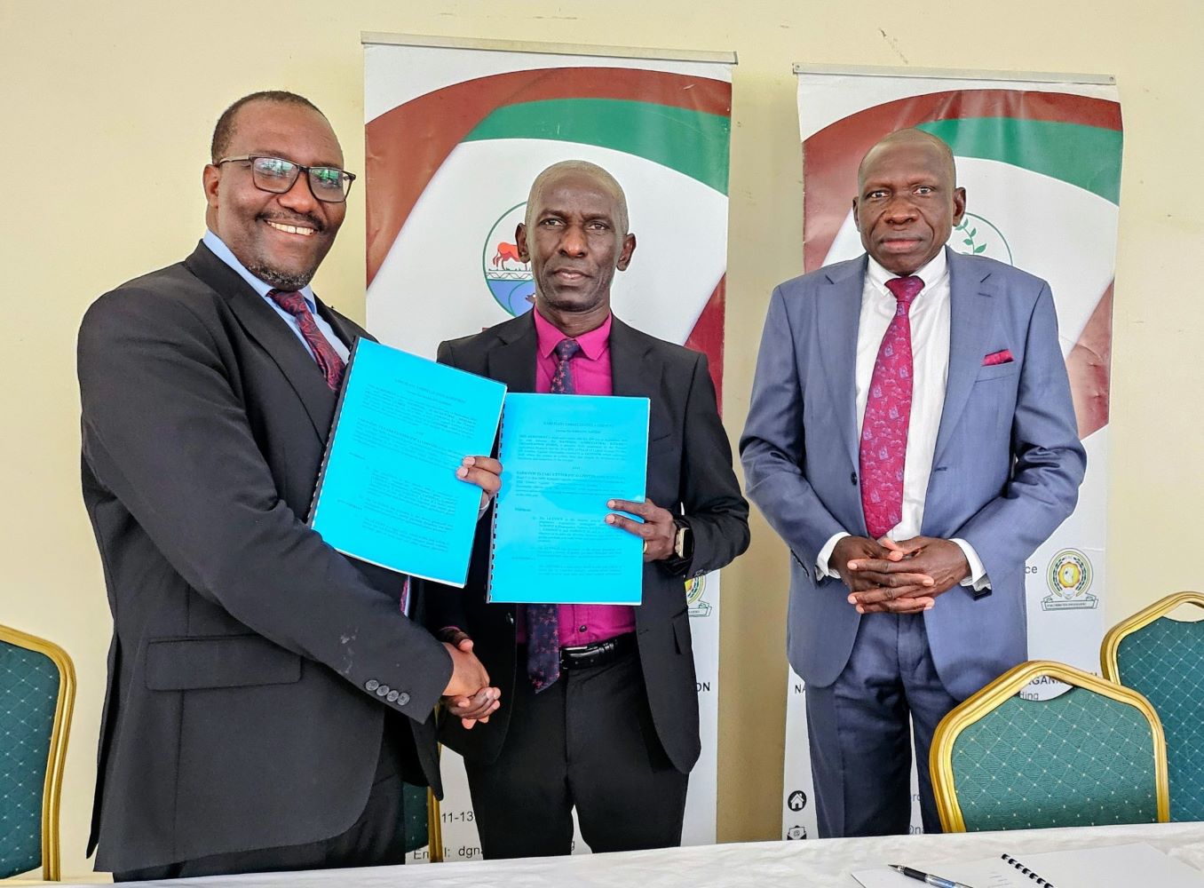 NARO-Director-General-Dr.-Yona-Baguma-center-exchanges-a-signed-license-with-the-Managing-Director-of-FICA-Seeds-Mr.-Narsis-Tushabe-after-the-signing-in-Kajjansi-1-2048x1510.jpg NEW